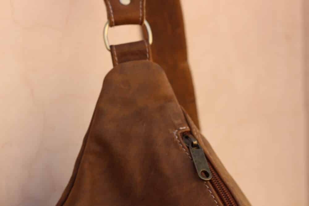 Leather Sling Bag worn crossbody by a man during a casual outing.