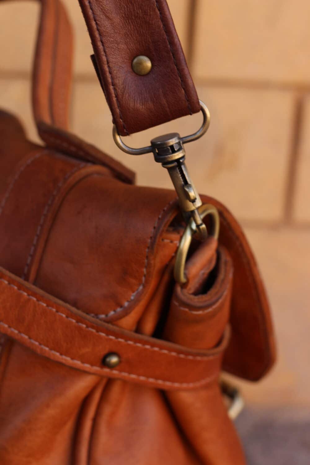 Leather Shoulder Bag carried by a woman during a casual outing.