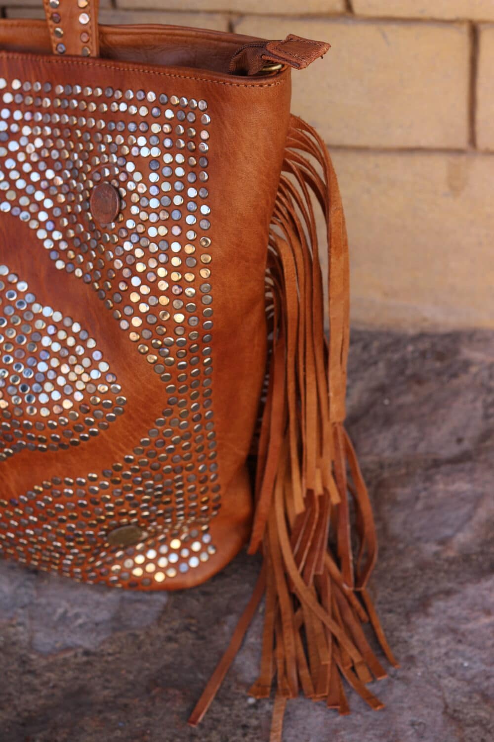 Brown leather cross the body bag with gold hardware and adjustable strap