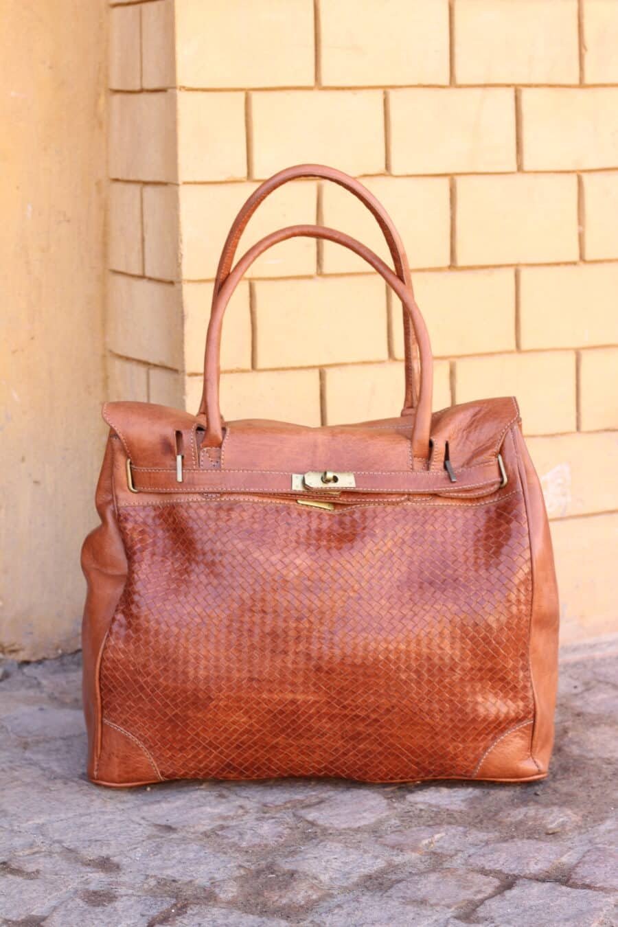 Leather Notebook Bag worn crossbody during a commute.