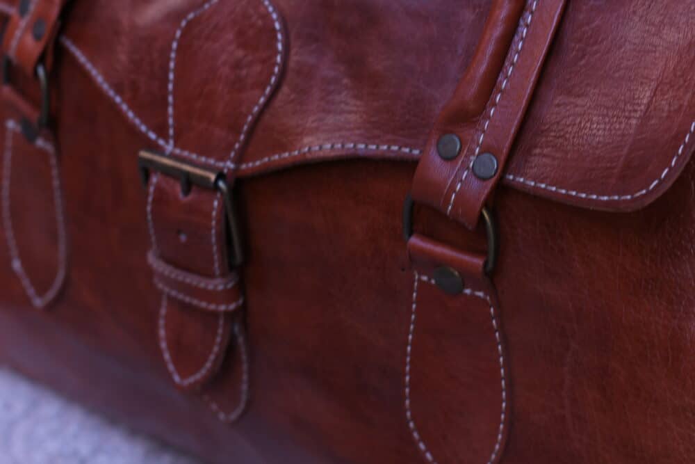 Close-up shot of premium leather surface on the travel bag.