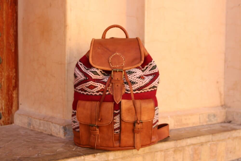 Genuine leather backpack with compartments and adjustable straps.