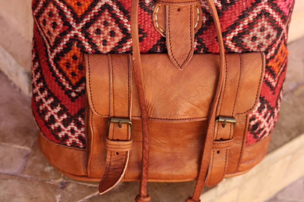 Woman wearing unique leather backpack purse as a backpack