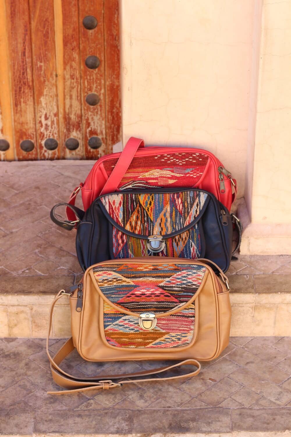 Vibrant handmade cross over leather bag with traditional Moroccan kilim patterns.