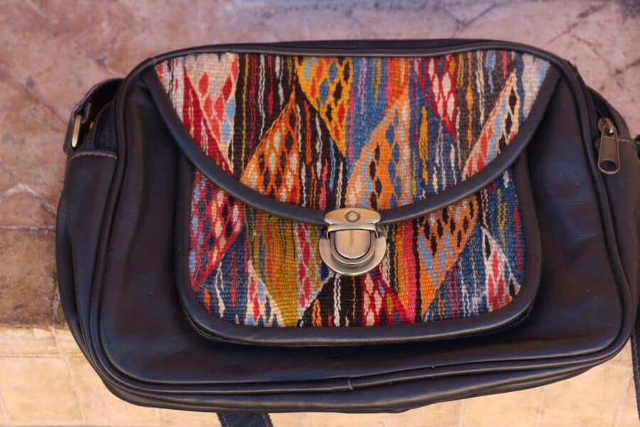 Vibrant handmade cross over leather bag with traditional Moroccan kilim patterns.