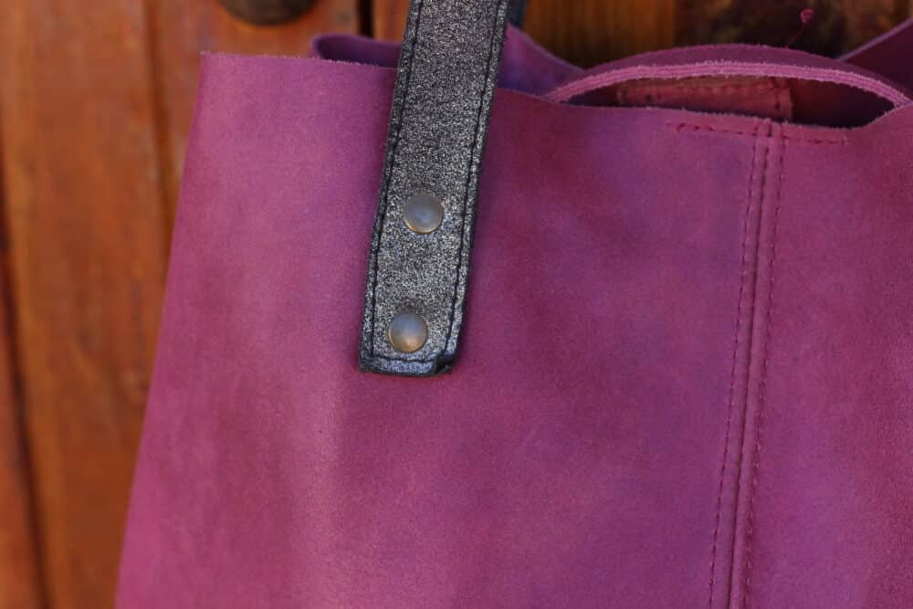 Optimal Leather Work Bag worn over shoulder with padded strap for comfort