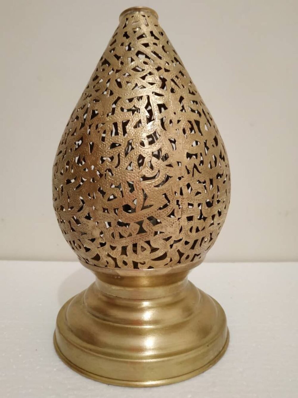 Close-up of the polished brass finish on the desk lamp.