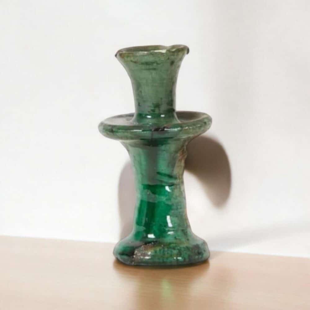 Decorative handmade ceramic candlestick holder in a cozy living room