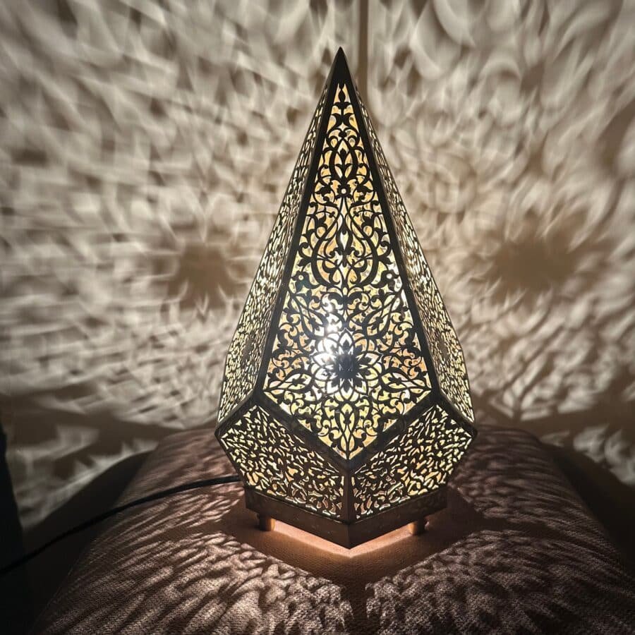 Luxury brass table light on a wooden desk in a modern living room.