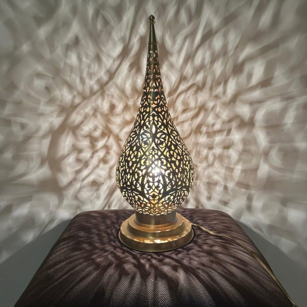 Compact and stylish gold table lamp displayed in a living room.