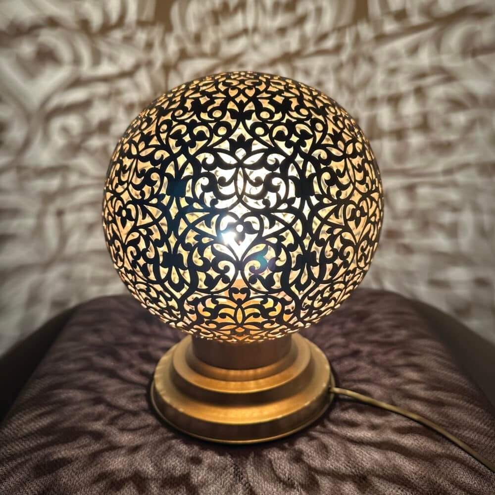 A close-up of the Astonishing Brass Lamp with its gleaming finish.