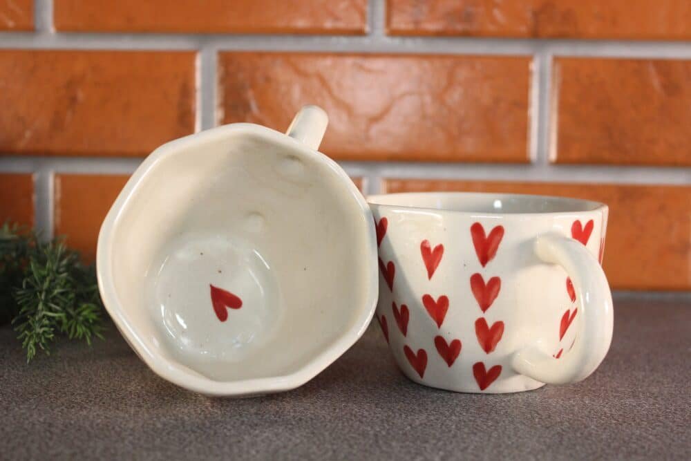 Person enjoying coffee from a Magic Ceramic Mug