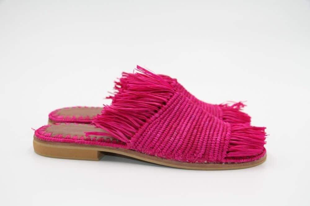 Close-up of the pink-purple raffia texture on sandals